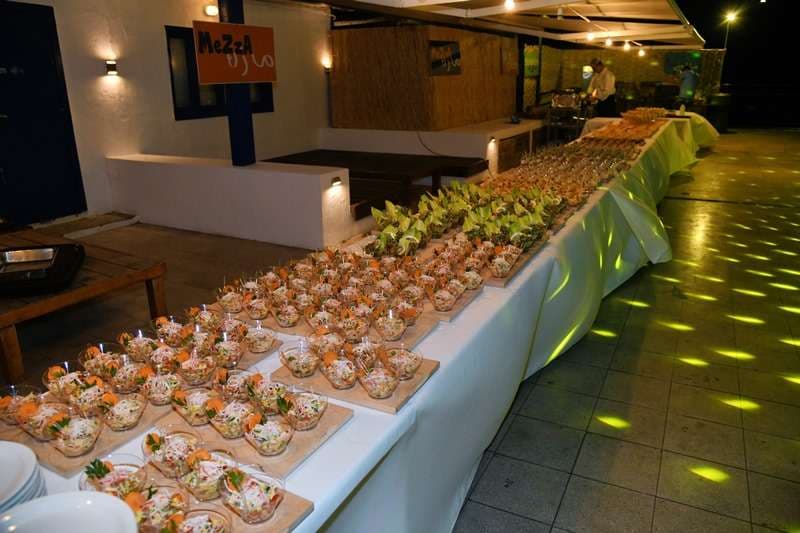 Cones of fried whitebait with lemon set out for service at Sporting Club Beach