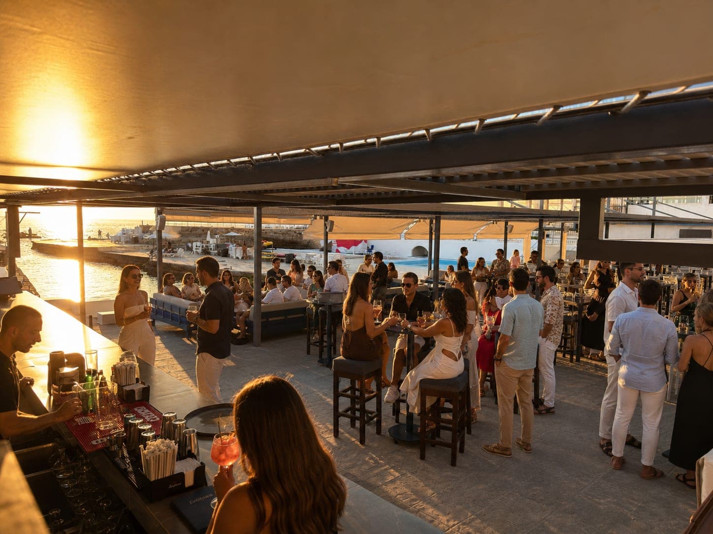 An evening on the Sunset Bar terrace, the pools and the sea beyond, Sporting Club Beach