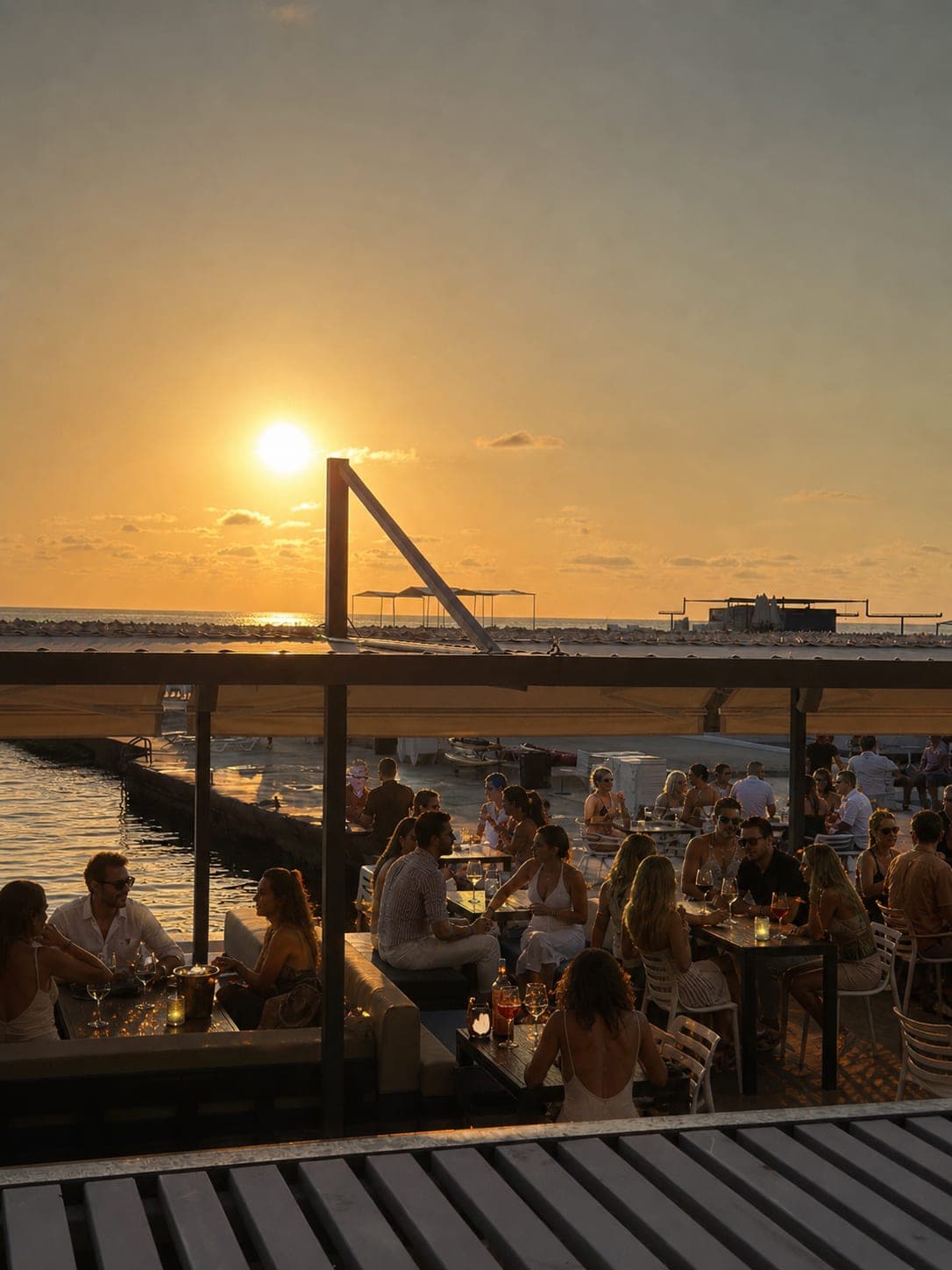 The sun going down over the Mediterranean from the Sunset Bar terrace at Sporting Club Beach