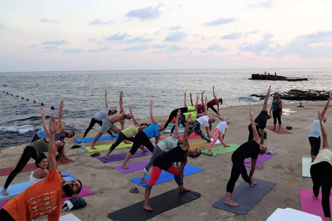 A yoga session on the open-air training terrace at Sporting Club Beach